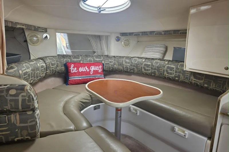 Slide: The Image of Interior of 2000 Monterey 302 Cruiser with cozy seating and decorative pillows. - 3