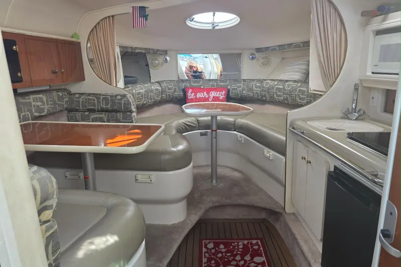 Slide: The Image of Interior of a 2000 Monterey 302 Cruiser with seating, kitchenette, and table. - 5