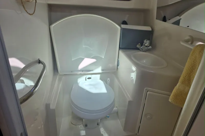 Slide: The Image of Compact bathroom in 2000 Monterey 302 Cruiser with toilet, sink, and towel. - 6