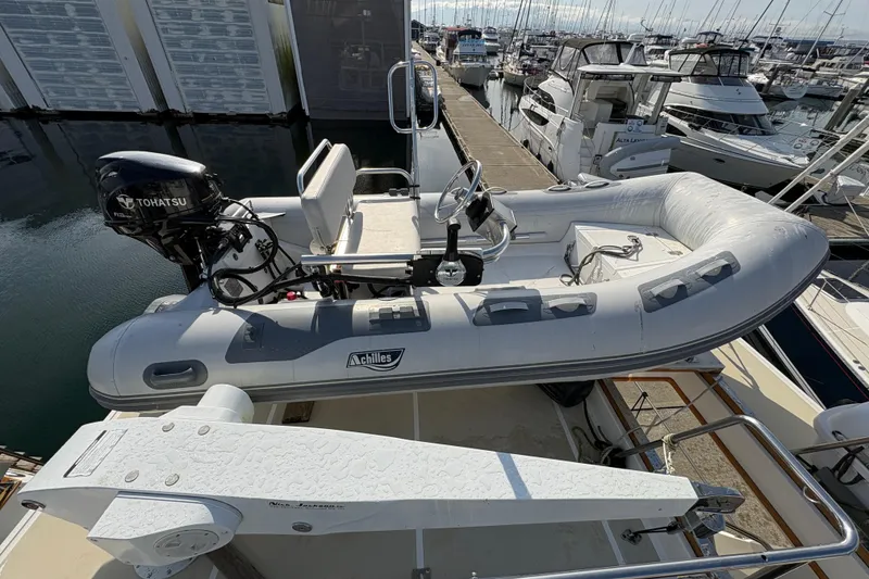 Slide: The Image of Inflatable boat on a 1998 Grand Banks 52 Europa yacht, docked at a marina. - 11