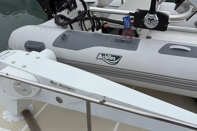 Slide: The Image of 1998 Grand Banks 52 Europa yacht docked at marina, featuring spacious deck and seating area. - 12