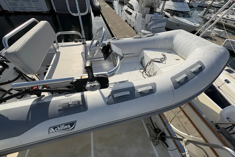 Slide: The Image of 1998 Grand Banks 52 Europa yacht docked at marina, showcasing bow and anchor. - 14