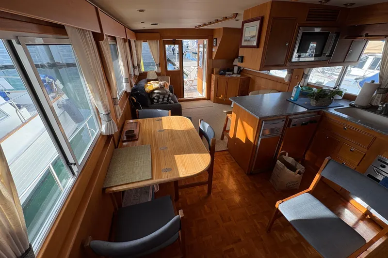 Slide: The Image of Interior of 1998 Grand Banks 52 Europa yacht with cozy seating and dining area. - 22