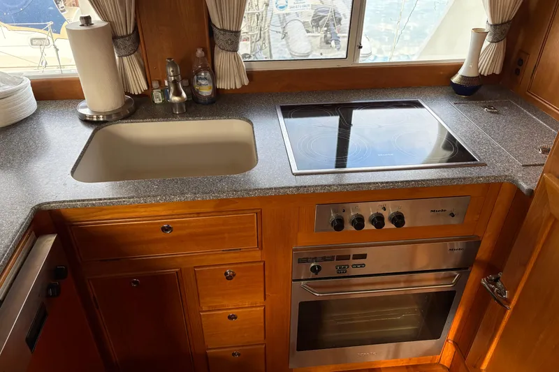 Slide: The Image of Interior of 1998 Grand Banks 52 Europa yacht with wood finish and dining area. - 25