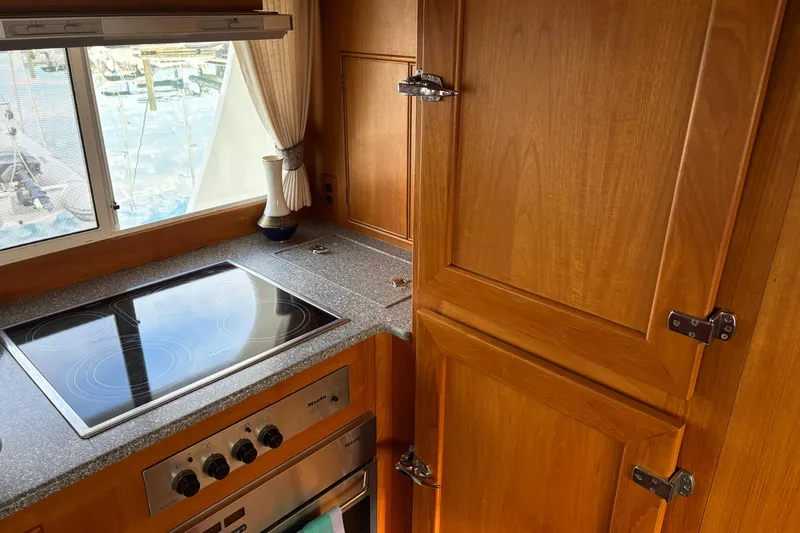 Slide: The Image of Kitchen area of 1998 Grand Banks 52 Europa yacht with appliances and wood cabinetry. - 27