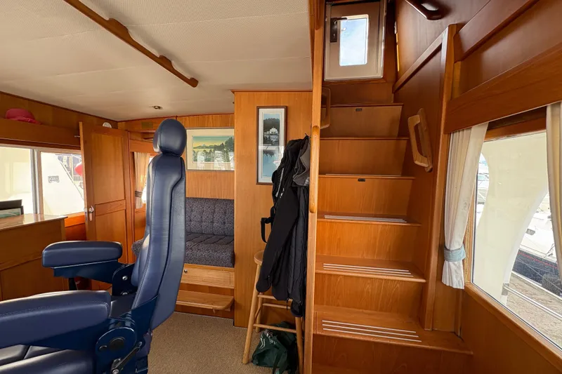 Slide: The Image of Helm of 1998 Grand Banks 52 Europa with navigation equipment and nautical charts. - 32