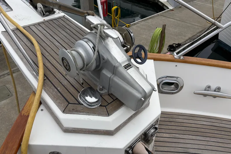 Slide: The Image of 1998 Grand Banks 52 Europa yacht deck with helm, seating, and wooden flooring. - 4