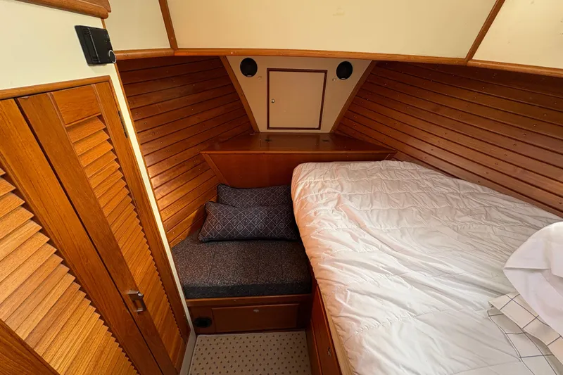 Slide: The Image of Cozy bedroom in 1998 Grand Banks 52 Europa yacht with nautical decor and wood paneling. - 43