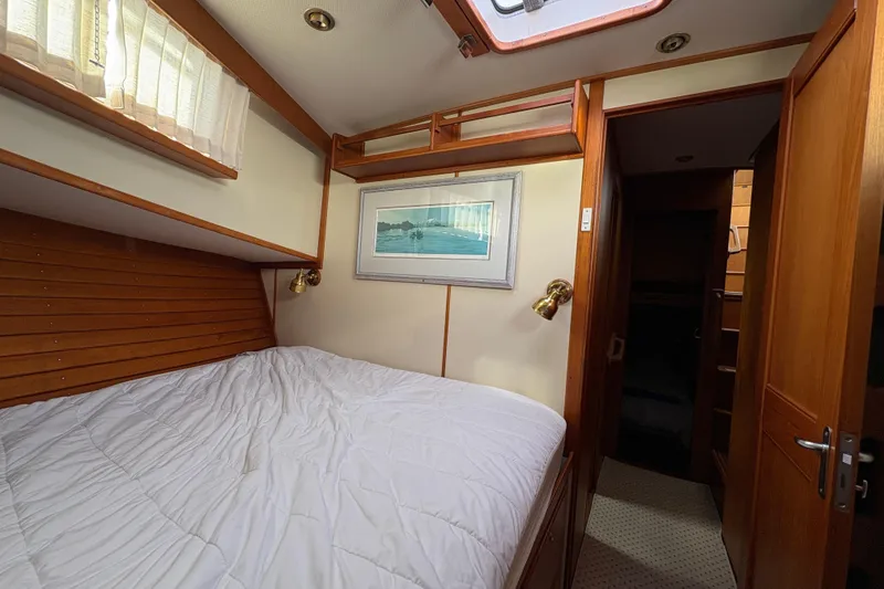 Slide: The Image of Cozy cabin interior of 1998 Grand Banks 52 Europa with wooden paneling and comfortable bedding. - 44