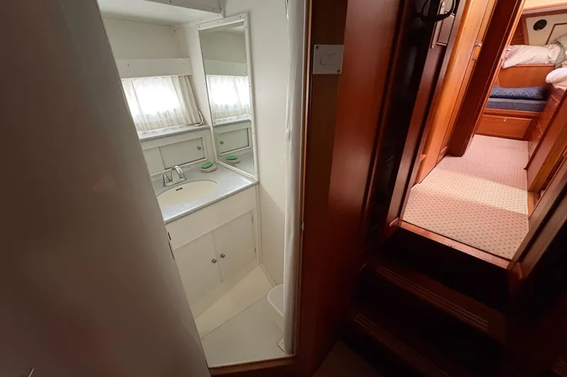 Slide: The Image of Cozy bedroom in 1998 Grand Banks 52 Europa yacht with wooden accents and decorative pillows. - 46