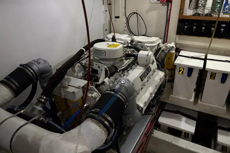 Slide: The Image of Engine room of 1998 Grand Banks 52 Europa yacht with dual engines and control panels. - 48