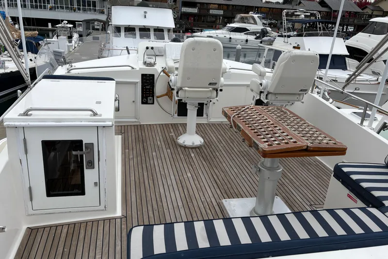 Slide: The Image of Deck view of a 1998 Grand Banks 52 Europa yacht with a mounted grill. - 6