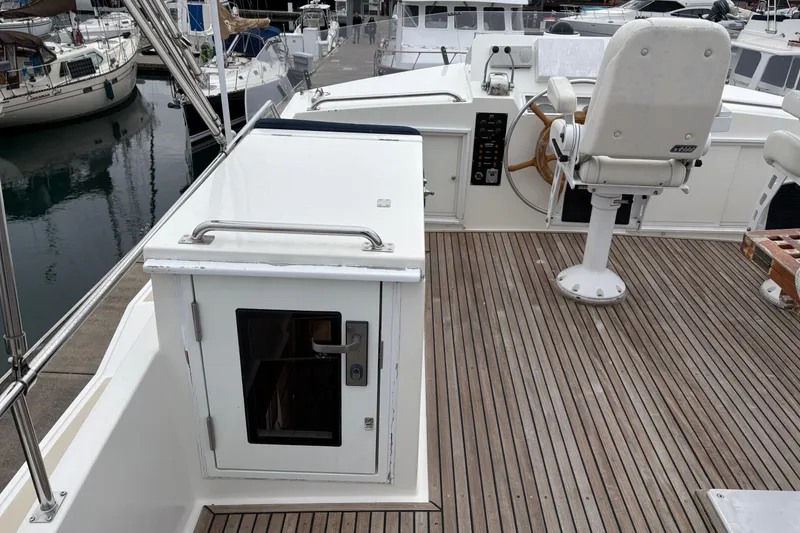 Slide: The Image of A 1998 Grand Banks 52 Europa yacht with an inflatable dinghy and Tohatsu motor on deck. - 7