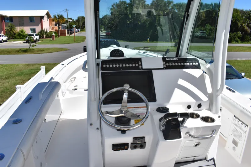 Slide: The Image of 2018 Everglades 273 Center Console boat interior with steering wheel and control panel. - 14