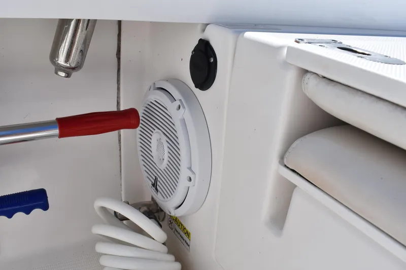 Slide: The Image of 2018 Everglades 273 Center Console boat interior with speaker and coiled hose. - 27