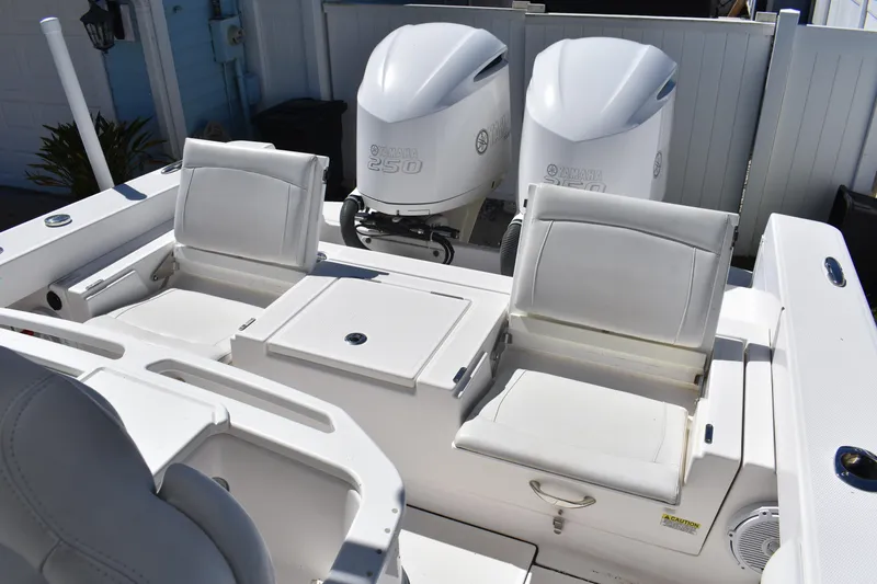 Slide: The Image of 2018 Everglades 273 Center Console boat with dual Yamaha 250 engines and white seating. - 9