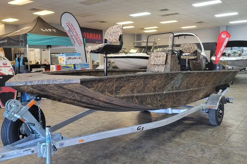 Slide: The Image of Camouflage-patterned G3 17CC boat on display in showroom, 2026 model. - 2