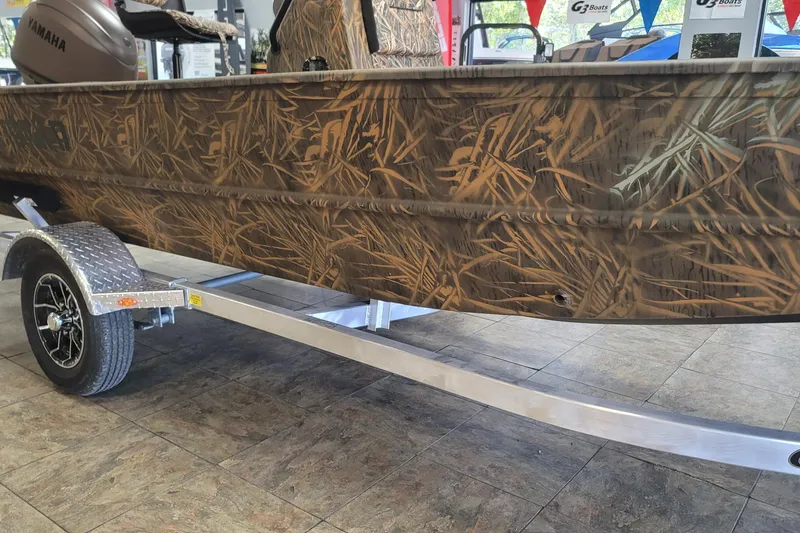 Slide: The Image of 2026 G3 17CC boat with camouflage design on a trailer in showroom. - 20