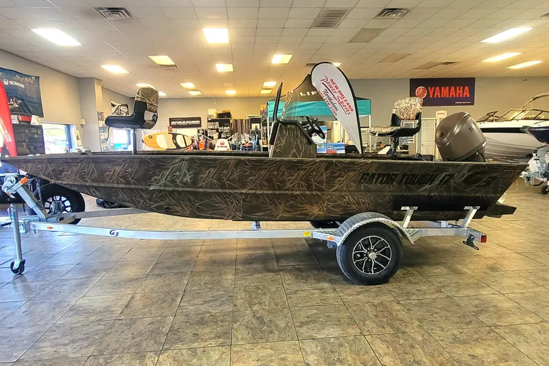 Slide: The Image of 2026 G3 17CC boat with camouflage design on display in showroom. - 3