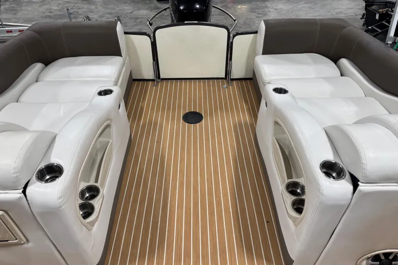 Slide: The Image of Interior of 2014 Premier 290 Grand Isle boat with white seating and wood-style flooring. - 10