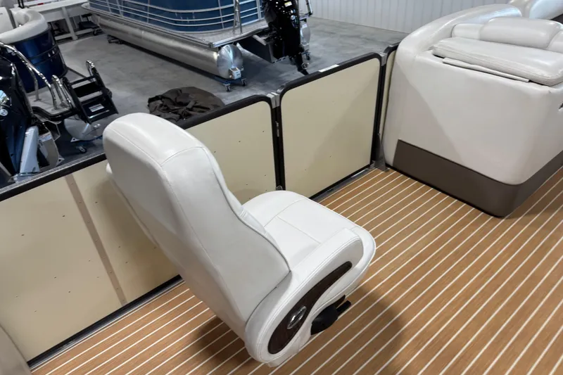 Slide: The Image of 2014 Premier 290 Grand Isle boat interior with white seating and striped flooring. - 11