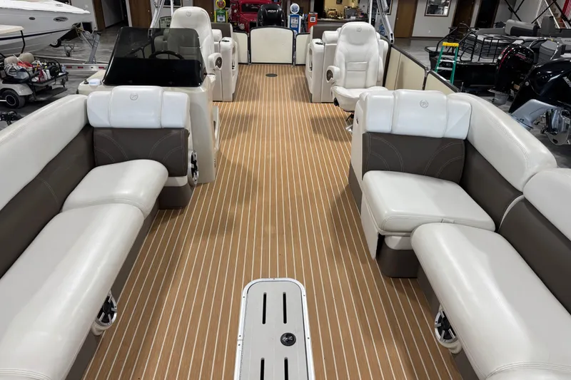 Slide: The Image of 2014 Premier 290 Grand Isle 10' Wide pontoon boat interior with luxurious seating and wood-style flooring. - 13