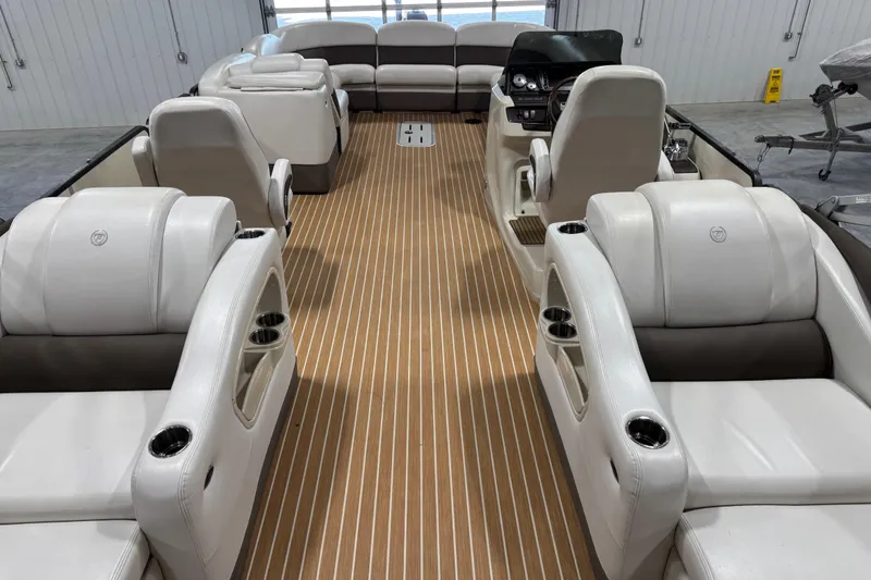 Slide: The Image of 2014 Premier 290 Grand Isle 10' Wide pontoon boat interior with luxurious seating and wood-style flooring. - 7