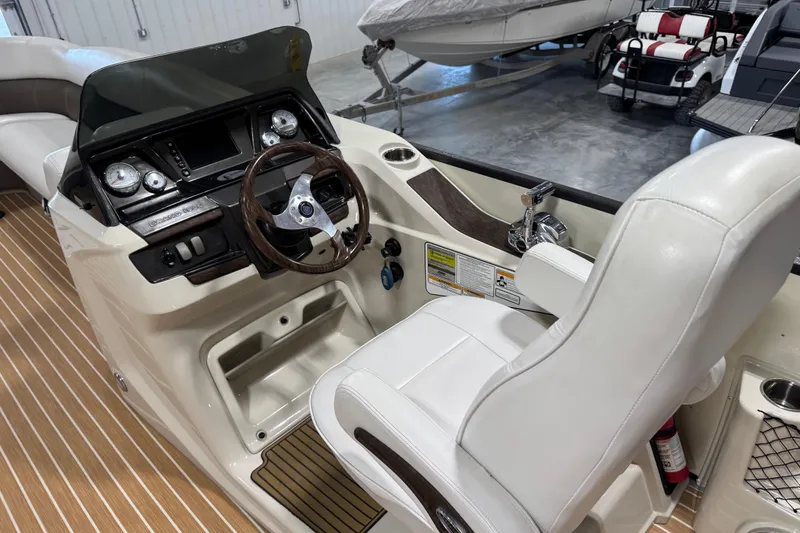 Slide: The Image of 2014 Premier 290 Grand Isle boat cockpit with steering wheel and control panel. - 8