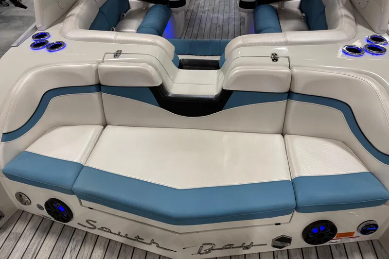 Slide: The Image of Luxurious seating on 2015 South Bay 925 Super Sport boat with blue and white upholstery. - 11
