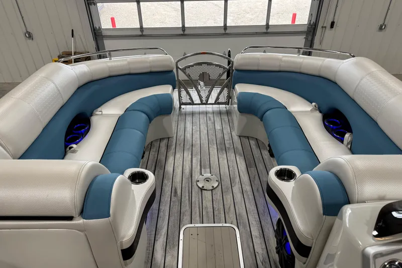 Slide: The Image of 2015 South Bay 925 Super Sport boat interior with blue and white seating, wood flooring. - 14