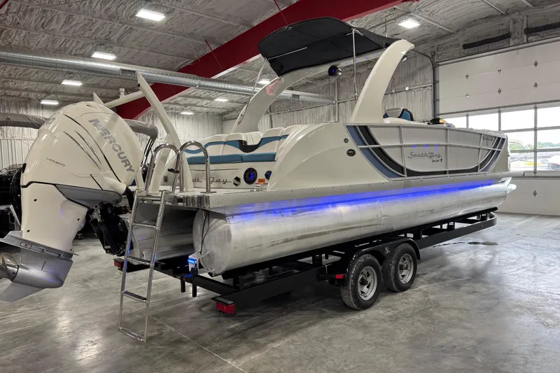 Slide: The Image of 2015 South Bay 925 Super Sport pontoon boat with Mercury engine in a garage. - 3