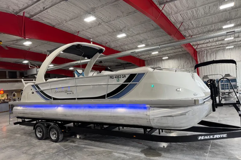 Slide: The Image of 2015 South Bay 925 Super Sport pontoon boat on trailer in indoor storage facility. - 5