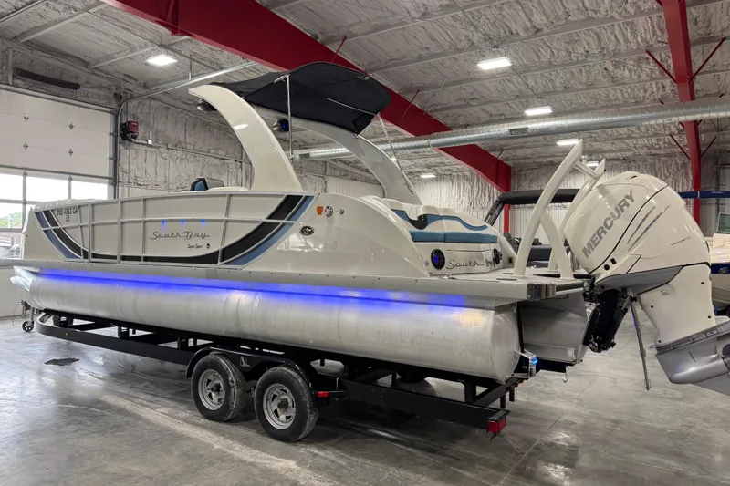 Slide: The Image of 2015 South Bay 925 Super Sport pontoon boat with Mercury outboard in a warehouse. - 8