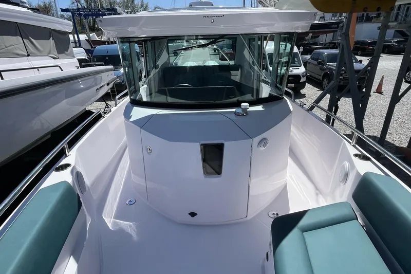 Slide: The Image of 2023 Axopar 28 Cabin boat with sleek design and spacious seating. - 26