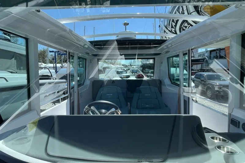 Slide: The Image of 2023 Axopar 28 Cabin interior with modern steering and seating. - 29