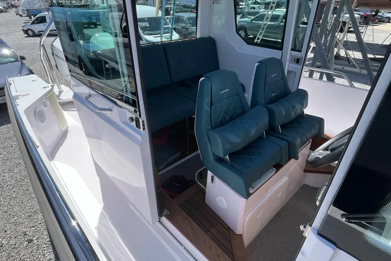 Slide: The Image of 2023 Axopar 28 Cabin interior with blue seating and modern design. - 30