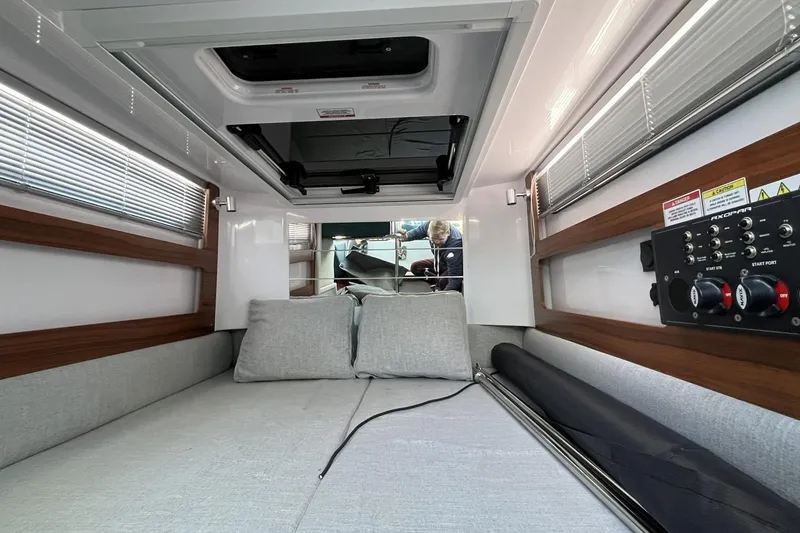 Slide: The Image of 2023 Axopar 28 Cabin interior with bed, control panel, and modern design. - 41