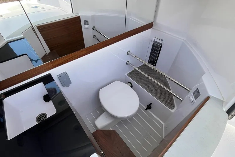 Slide: The Image of Modern bathroom interior in 2023 Axopar 28 Cabin boat, featuring sleek design and amenities. - 42