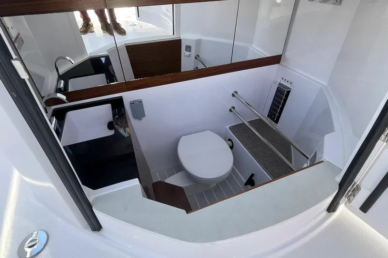 Slide: The Image of 2023 Axopar 28 Cabin boat interior with compact bathroom and modern fixtures. - 43