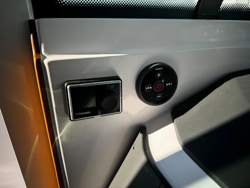 Slide: The Image of Control panel of 2023 Axopar 28 CABIN boat, featuring modern navigation and audio controls. - 6