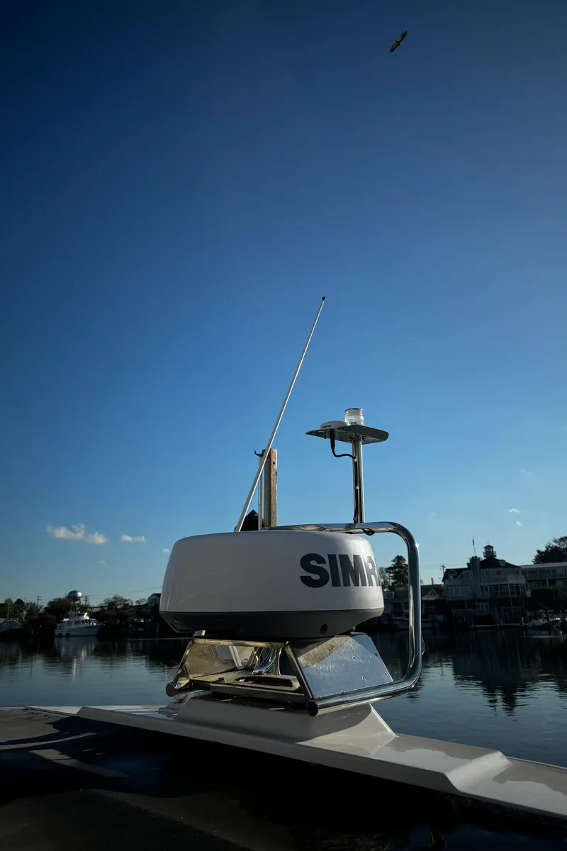 Slide: The Image of 2023 Axopar 28 CABIN boat with radar system on calm water. - 8