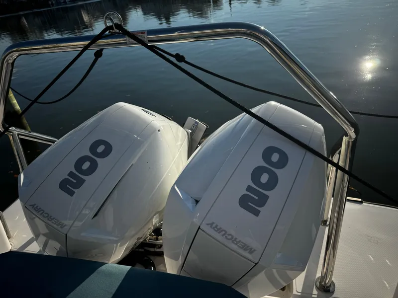 Slide: The Image of 2023 Axopar 28 CABIN with twin Mercury outboard engines on calm water. - 9