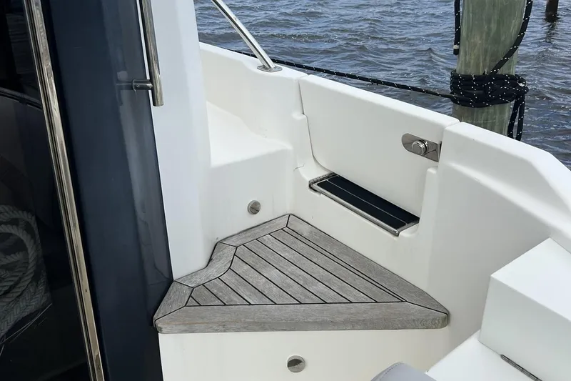 Slide: The Image of 2019 Sea Ray L550 yacht deck with railing, overlooking marina and buildings. - 10
