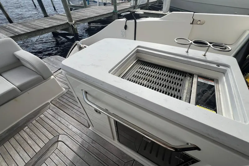 Slide: The Image of 2019 Sea Ray L550 yacht with TracVision and Raymarine equipment, docked under clear blue sky. - 14