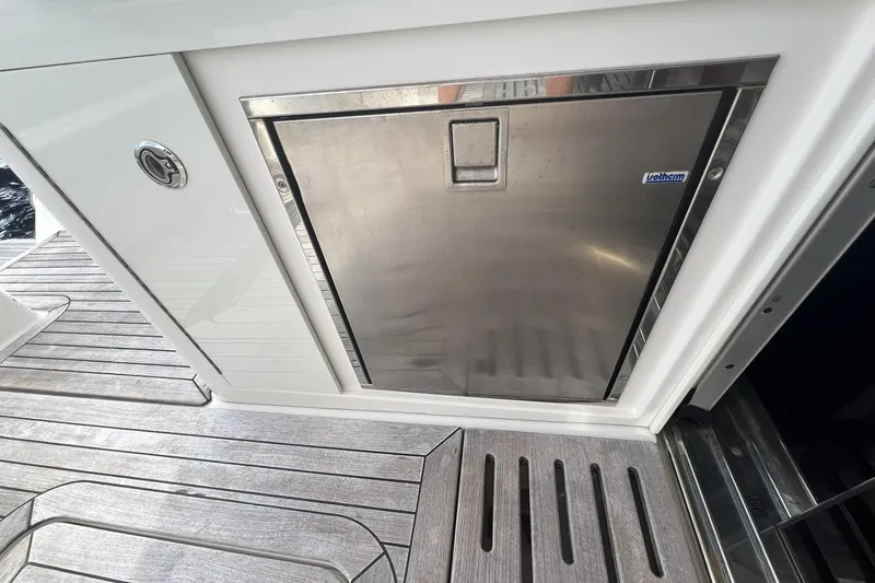 Slide: The Image of 2019 Sea Ray L550 yacht with spacious wooden swim platform at dock. - 15