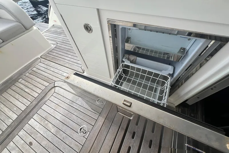 Slide: The Image of 2019 Sea Ray L550 yacht docked at a wooden pier on a sunny day. - 16