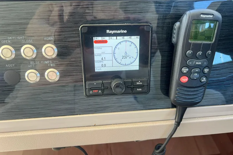 Slide: The Image of Open storage compartment on 2019 Sea Ray L550 boat with cleaning supplies and life jackets. - 22