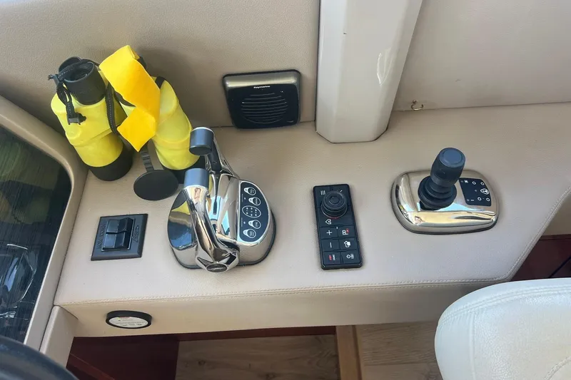 Slide: The Image of 2019 Sea Ray L550 yacht deck with wooden flooring and water view. - 24