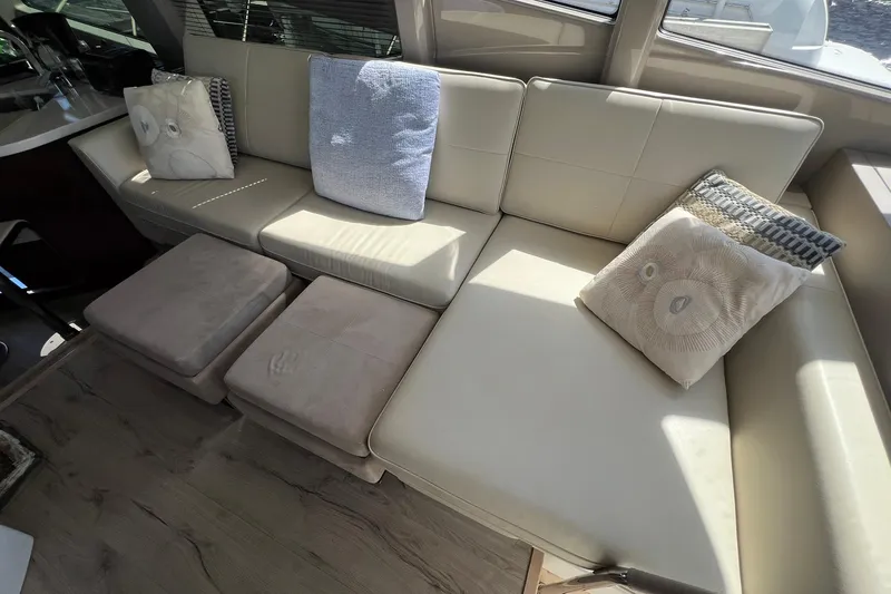 Slide: The Image of Luxurious seating area on 2019 Sea Ray L550 yacht with wooden table. - 30