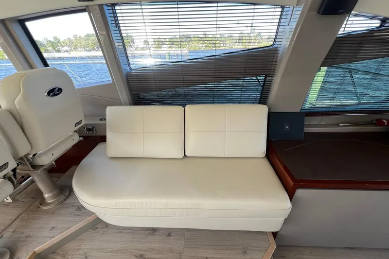 Slide: The Image of Luxurious seating area on 2019 Sea Ray L550 yacht with wooden table. - 31